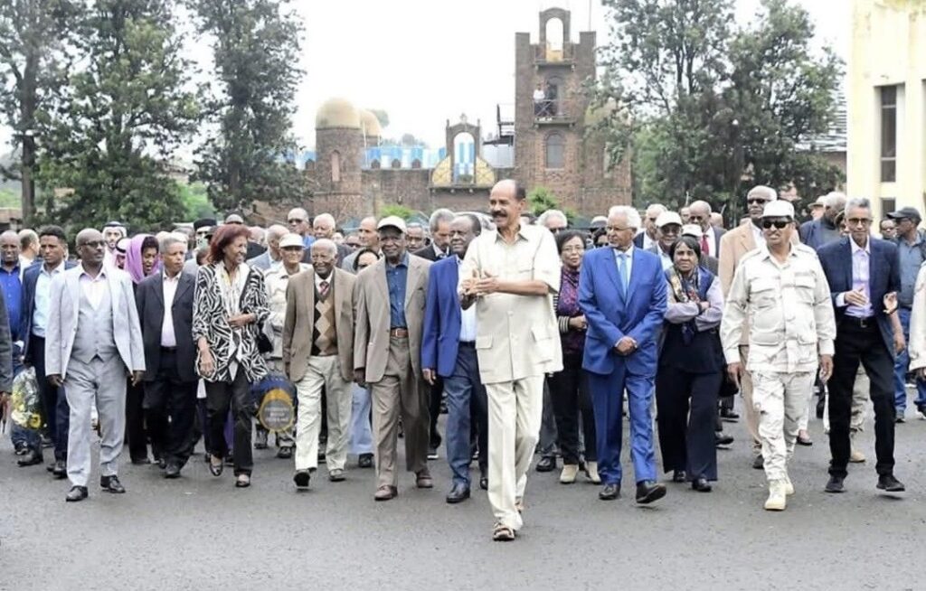 Eritrean President Isaias Afwerki walks with government officials to attend a national festival in Asmara.